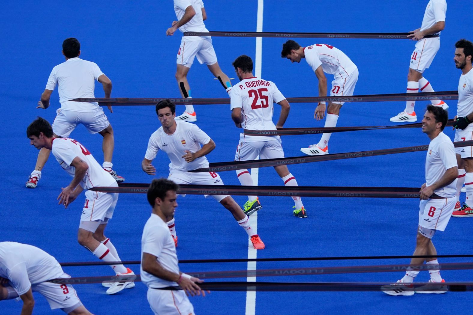 Field hockey players from Spain warm up before their match against Belgium on August 1.