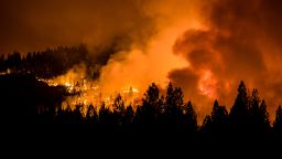 The Dixie fire burns through the night illuminating the smoke above.
Dixie fire at night in Meadow Valley, US - 31 Jul 2021
