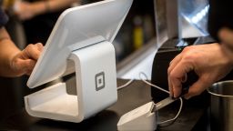 A customer inserts a credit card into Square Inc. device while making a payment in San Francisco, California, U.S., on Tuesday, March 27, 2018. 
