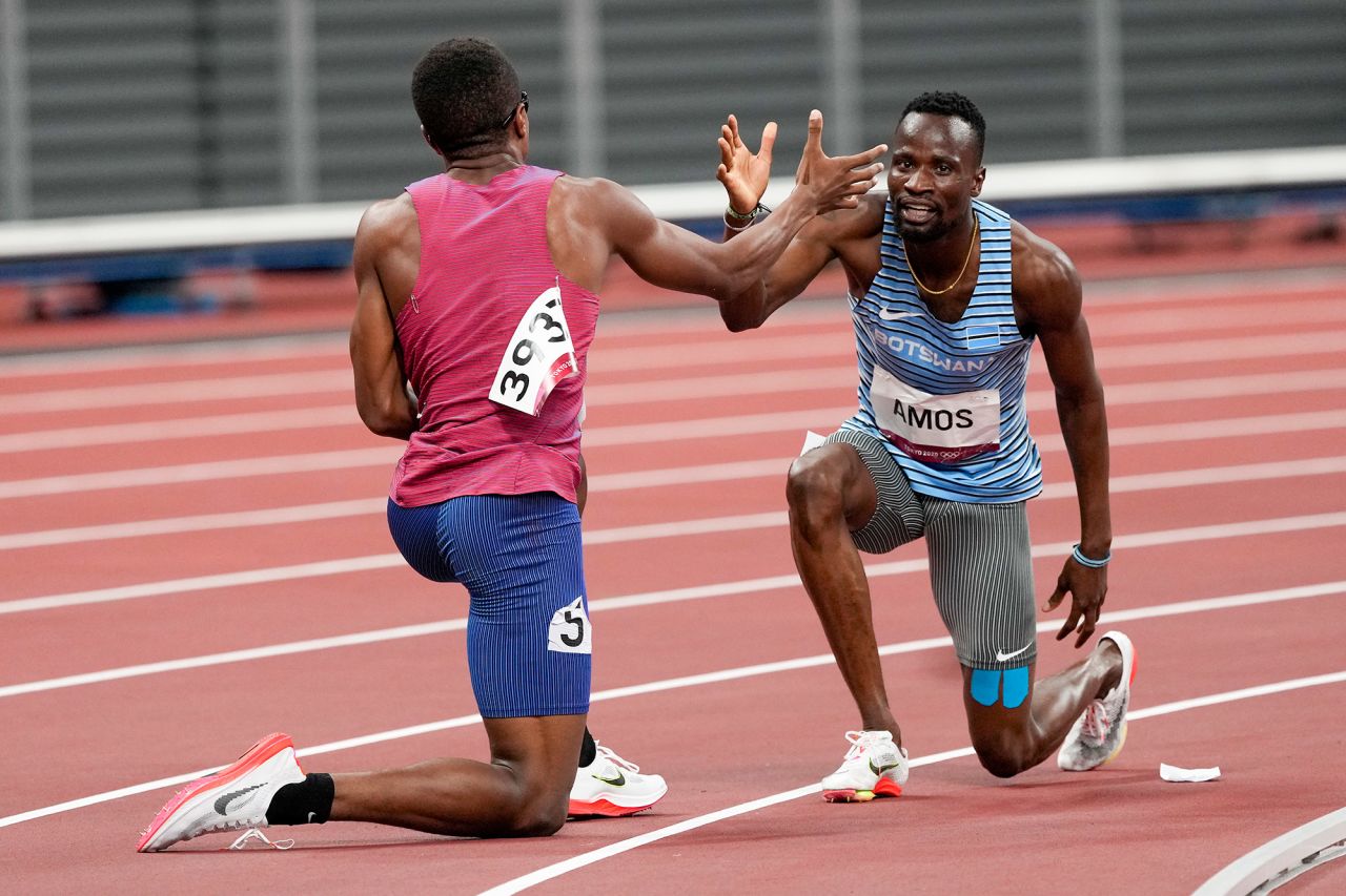 The United States' Isaiah Jewett, left, and Botswana's Nijel Amos help each other to their feet after falling during an 800-meter semifinal on August 1. They embraced and went on to finish the race together. 