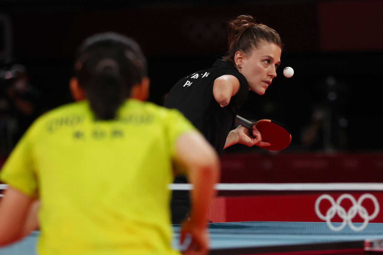 Polish table-tennis player Natalia Partyka, who was born without a right hand and forearm, eyes the ball during a doubles match on August 2. In the foreground is South Korea's Choi Hyo-joo. Partyka has competed in both the Olympics and the Paralympics.