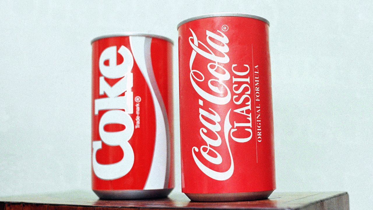 In this July 11, 1985 photo, cans of New Coke and Coca-Cola Classic are on display during a news conference in Atlanta. 