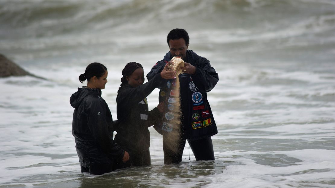 Divers scatter sand from Mozambique near the site where the wreckage of the Sao Jose-Paquete de Africa was found.