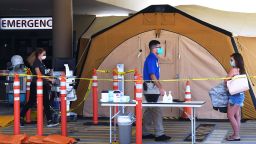 A woman arrives at a treatment tent outside the emergency department at Palm Bay Hospital. 29 Jul 2021
The tent was set up to serve as an overflow area as the number of COVID-19 infections surges throughout Brevard County, Florida due to the Delta variant and large numbers of unvaccinated residents. (Photo by Paul Hennessy / SOPA Images/Sipa USA)