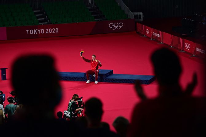 Denmark's Viktor Axelsen is applauded after receiving his <a href="index.php?page=&url=https%3A%2F%2Fwww.cnn.com%2Fworld%2Flive-news%2Ftokyo-2020-olympics-08-02-21-spt%2Fh_9eeee5368bdc8f9a5ecb35b3a3a125fc" target="_blank">badminton gold medal</a> on Monday, August 2. He is the first player from outside of Asia to win Olympic gold in men's singles in more than 20 years.