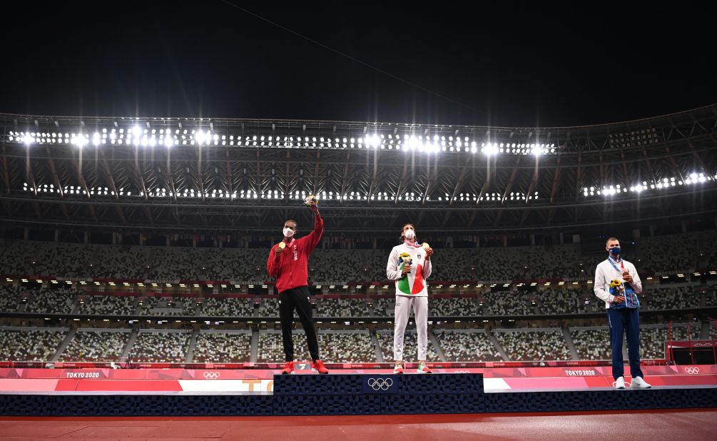 Qatar's Mutaz Essa Barshim, left, and Italy's Gianmarco Tamberi share the podium during a medal ceremony on August 2. <a href="https://www.cnn.com/world/live-news/tokyo-2020-olympics-08-01-21-spt/h_86532abc405785d7c29b0fda0e27cdce" target="_blank">They agreed to share the gold medal in high jump</a> after they both cleared 2.37 meters but failed to clear 2.39. Beside them is bronze medalist Maksim Nedasekau of Belarus. No one was given a silver medal.