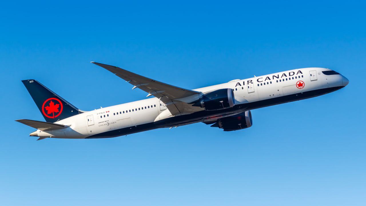 air canada plane in flight against blue sky