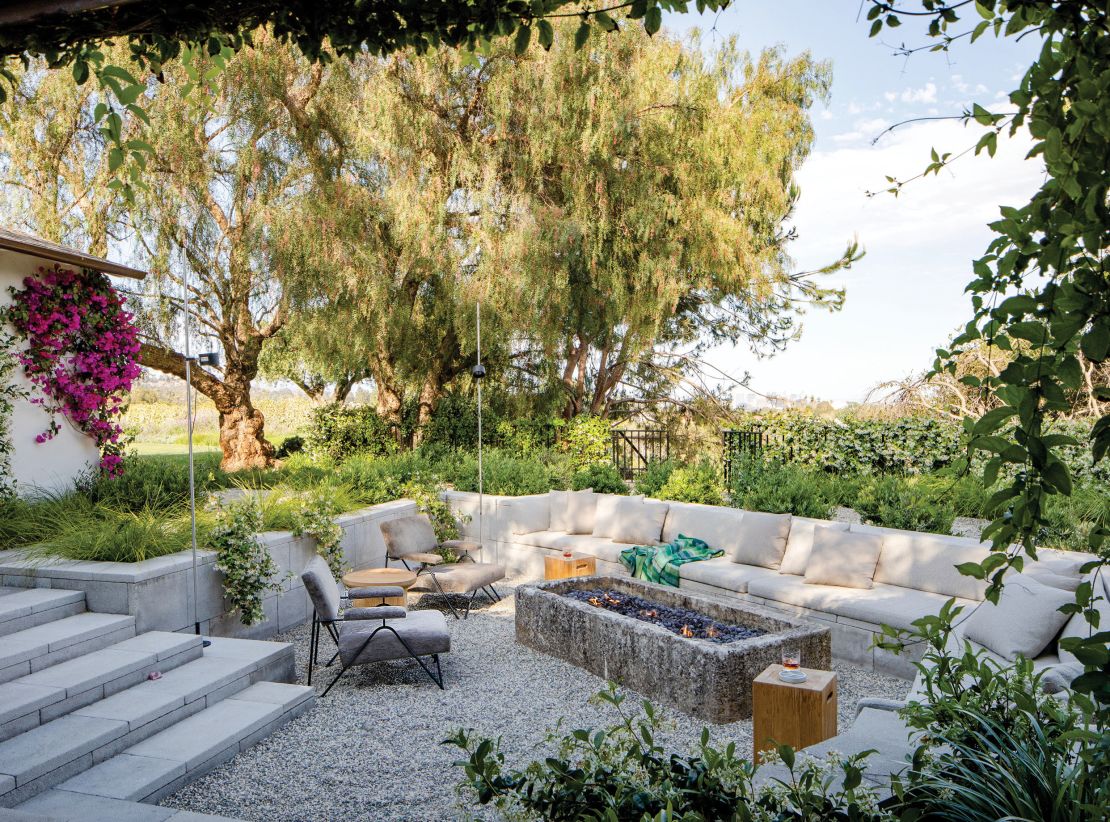 The conversation pit is situated in what looks like an Italian oasis.