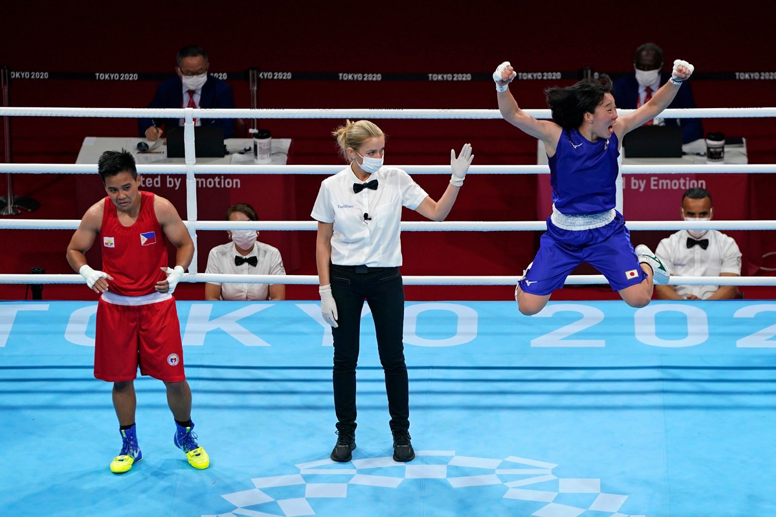 Japan's Sena Irie, right, celebrates after defeating the Philippines's Nesthy Petecio to win the women's featherweight final on August 3.