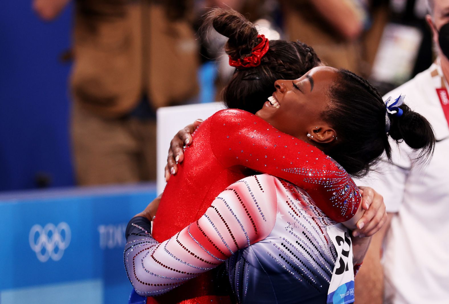 Biles is hugged by teammate Suni Lee, who was also competing in the event. Lee <a href="index.php?page=&url=http%3A%2F%2Fwww.cnn.com%2F2021%2F07%2F29%2Fsport%2Fgallery%2Fsuni-lee-gymnastics-gold-olympics%2Findex.html" target="_blank">won the individual all-around</a> last week.