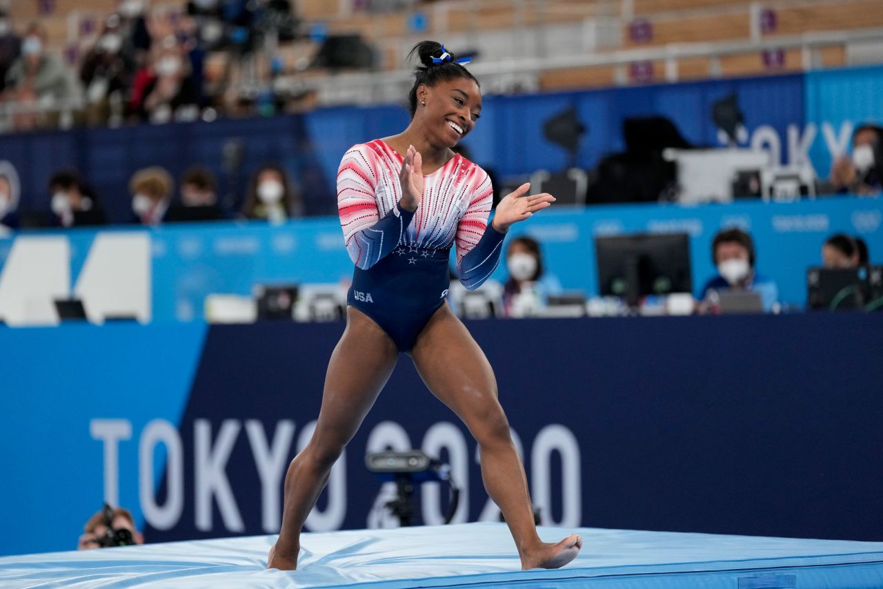 Biles claps after finishing her routine Tuesday.