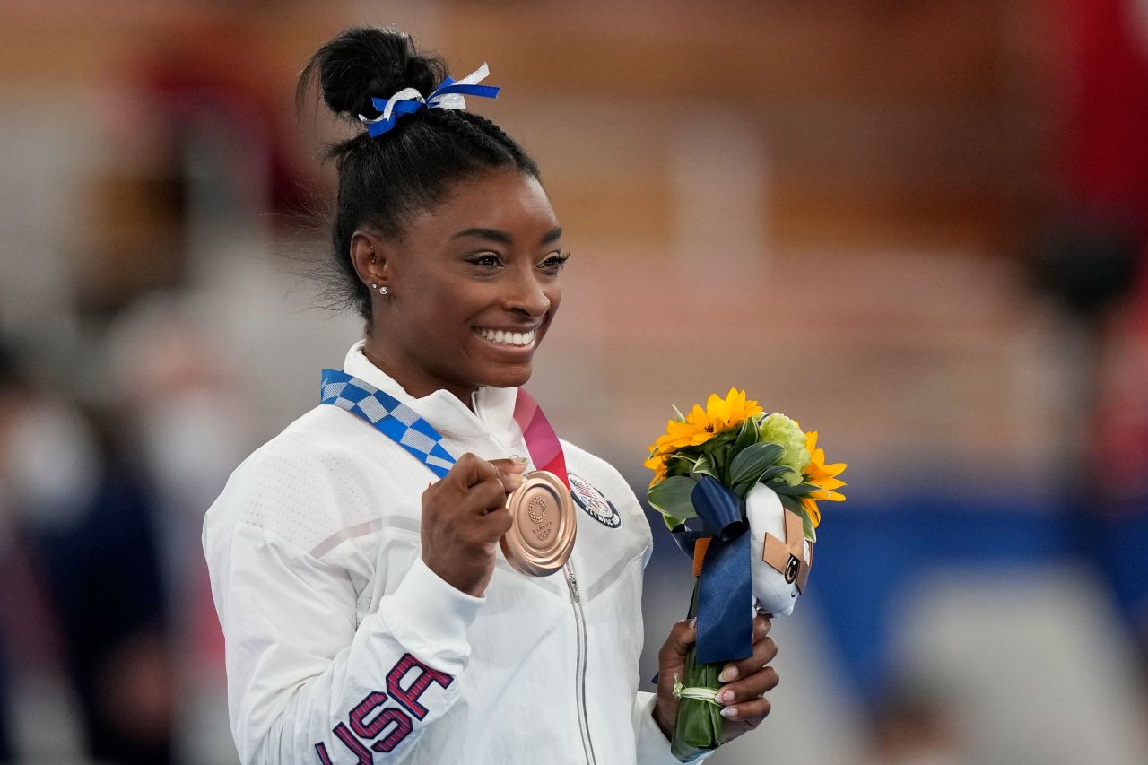 Biles poses with her bronze medal Tuesday. "It definitely feels more special, this bronze, than the balance beam bronze at Rio," she said. "I will cherish it for a long time." Biles now has seven Olympic medals, tying her with Shannon Miller for the most by an American gymnast.