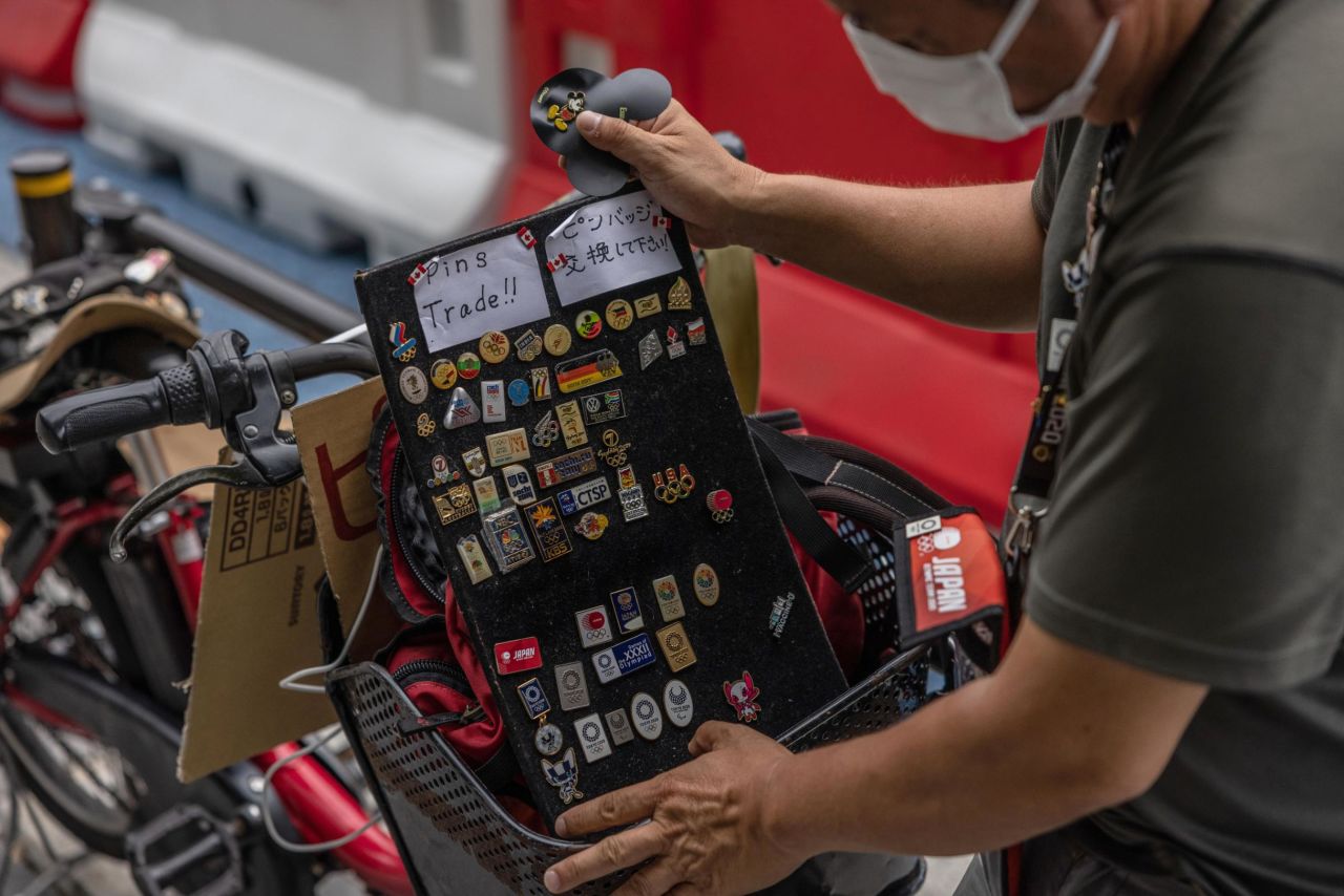 An Olympic pin collector waits to exchange pins with other collectors near the Tokyo's Olympic Stadium on July 29, 2021.