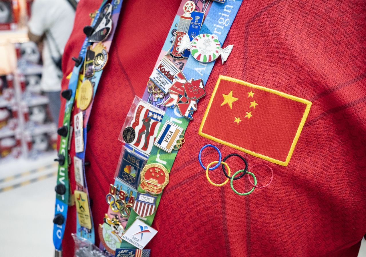 A collector shows her Olympic pins during Beijing's Olympic Pin Culture Week, part of the city's preparations for hosting the 2022 Winter Olympics.
