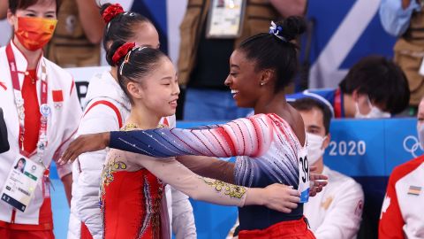 Biles and Guan embrace during the balance beam final. 