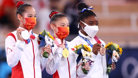 Tang Xijing, Guan Chenchen and Simone Biles pose with their medals after the women's balance beam final.  