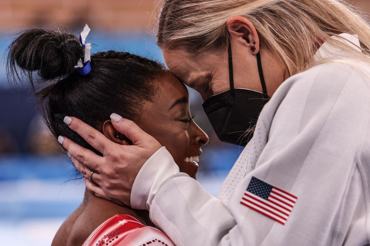 Coach Cecile Canqueteau-Landi congratulates Biles as it becomes evident she will earn a medal.