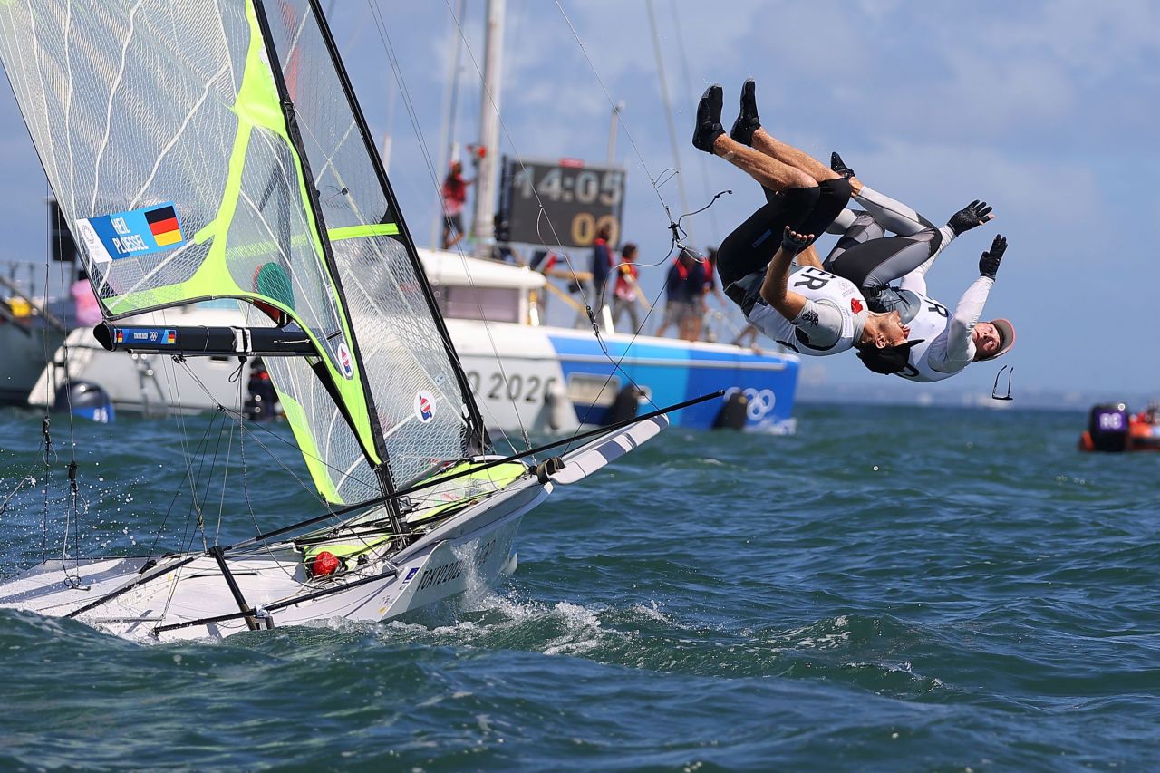 German sailors Erik Heil and Thomas Ploessel jump into the water as they celebrate winning bronze in the 49er category on August 3.