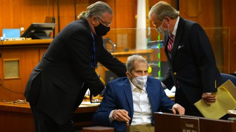 Defense attorneys David Z. Chesnoff, left, and Dick DeGuerin, right, adjust Robert Durst's wheelchair during opening statements in his murder trial on May 18, 2021.