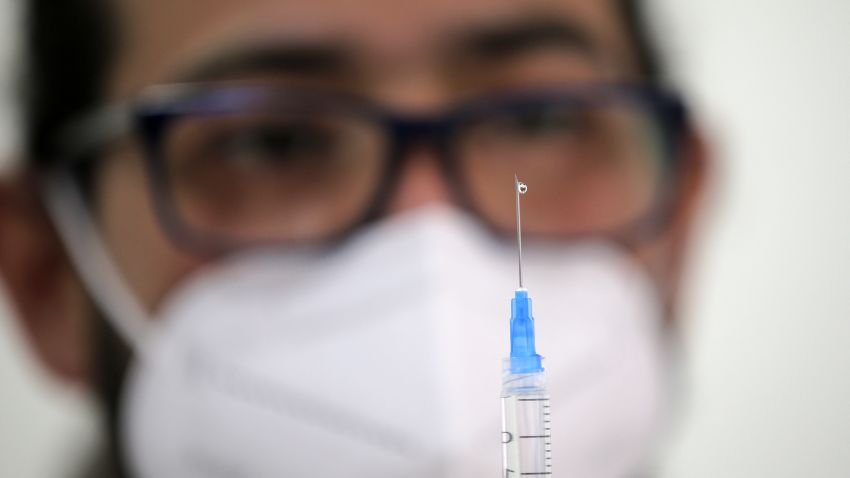 A health workers fills a syringe with a dose of the Pfizer-BioNTech vaccine against COVID-19 at a vaccination centre in Santiago, on July 12, 2021. (Photo by JAVIER TORRES / AFP) (Photo by JAVIER TORRES/AFP via Getty Images)