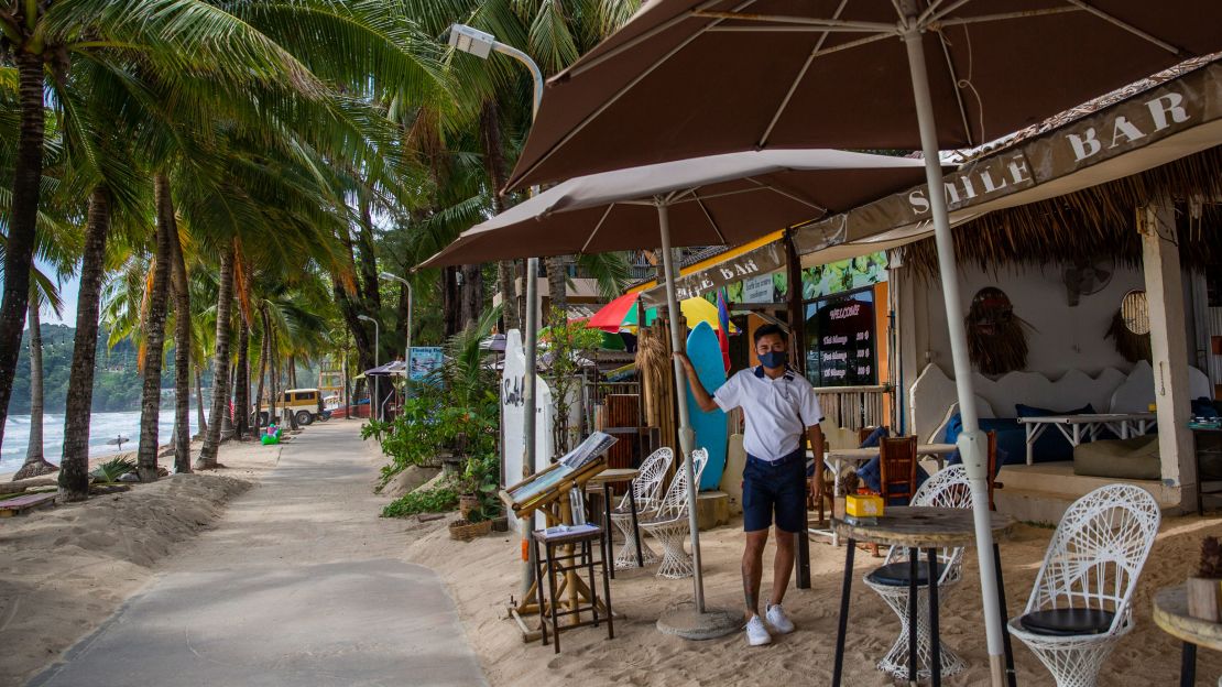 A worker waits for customers at a beachside restaurant on Phuket's Kamala Beach on July 19.