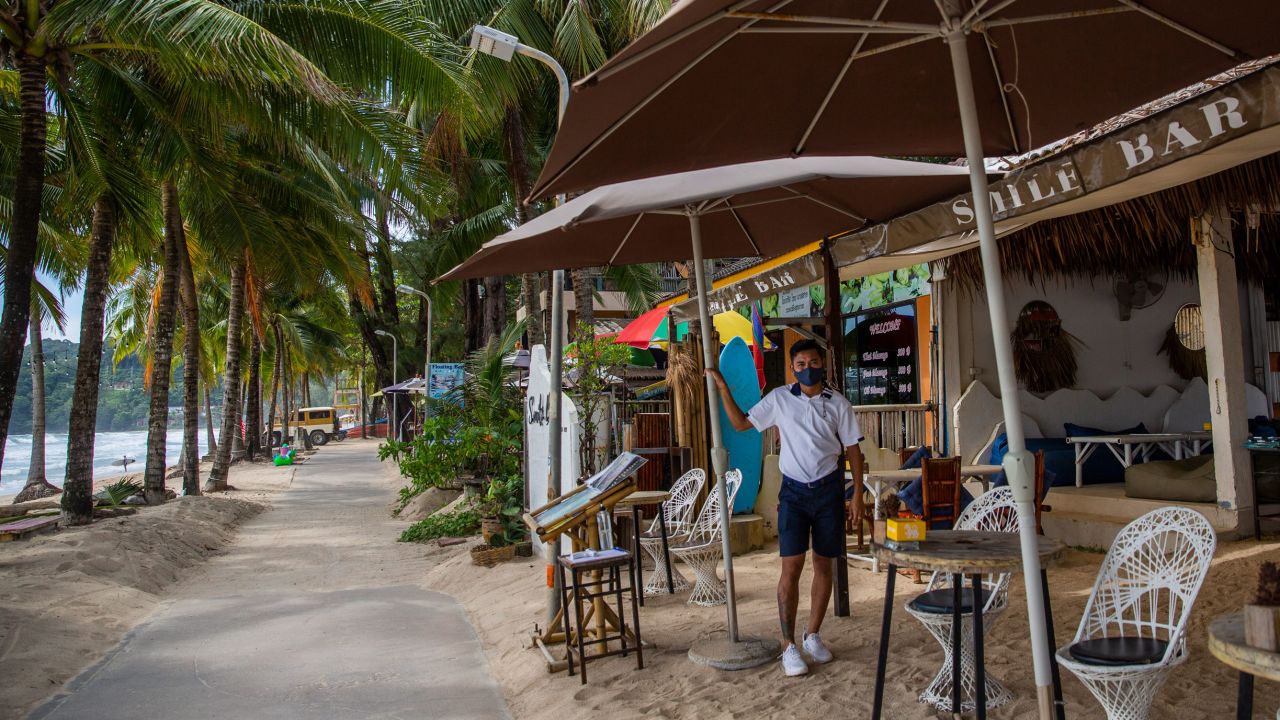 A worker waits for customers at a beachside restaurant on Phuket's Kamala Beach on July 19. 