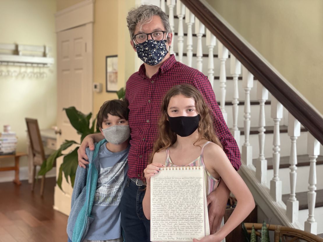 Matt Hartley with his children Will and Lila, all of whom want everyone in schools to wear masks.