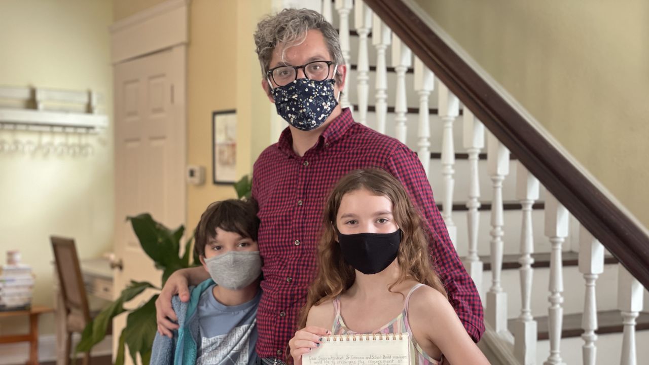 Matt Hartley with his children Will and Lila, all of whom want everyone in schools to wear masks.