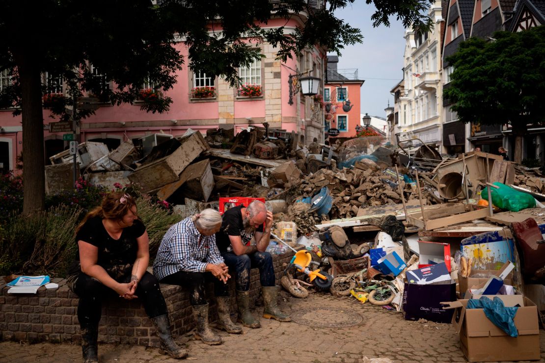 People take a break from cleaning up after flooding in Bad Neuenahr-Ahrweiler, Germany, in July.