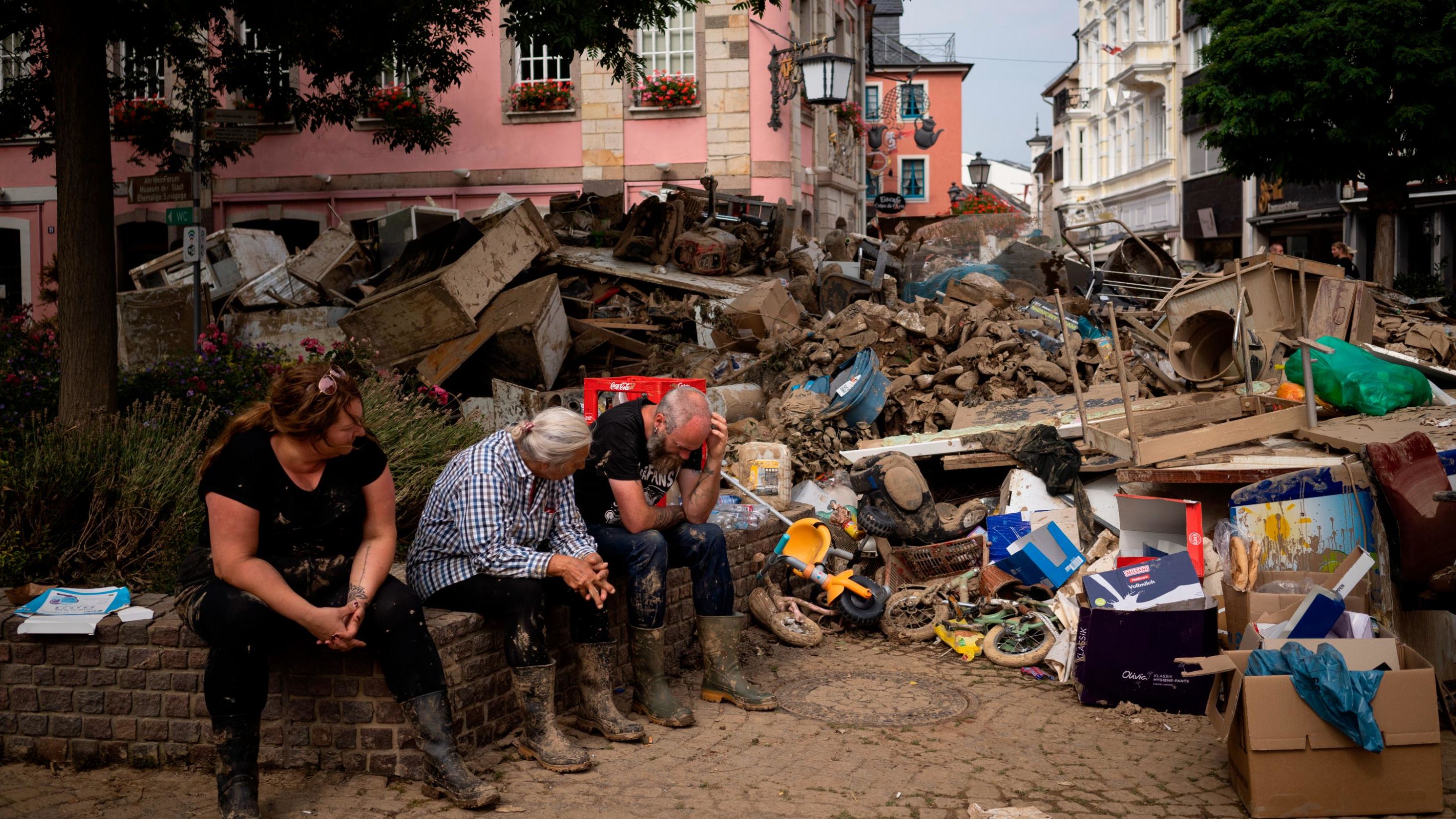 People take a break from cleaning up after flooding in Bad Neuenahr-Ahrweiler, Germany, in July.