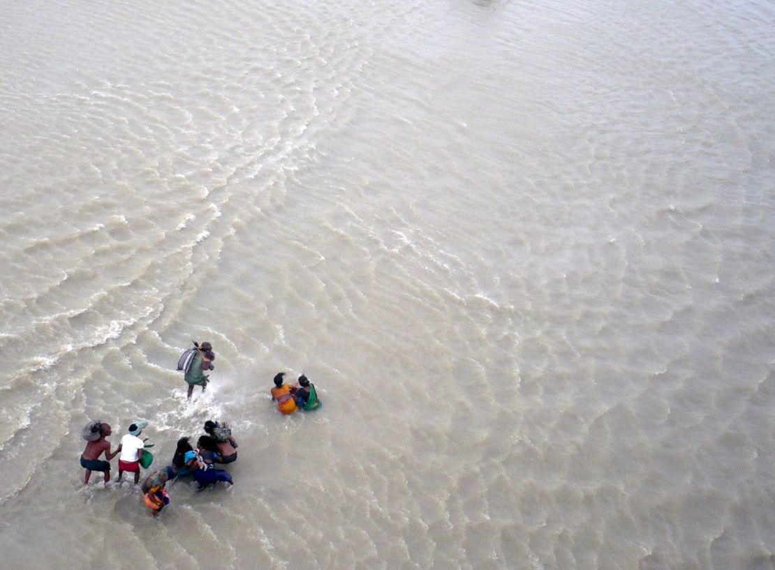 Victims wade through flood water along the Koshi River in Nepal in 2008.