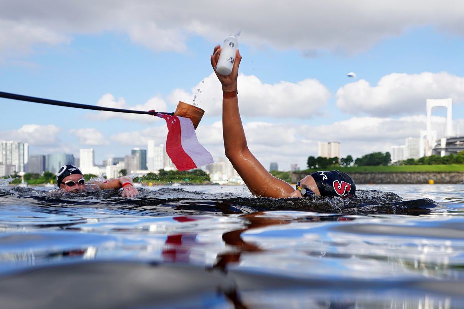 Singaporean swimmer Li-Shan Chantal Liew grabs a drink while competing in the 10-kilometer open-water event on August 4.