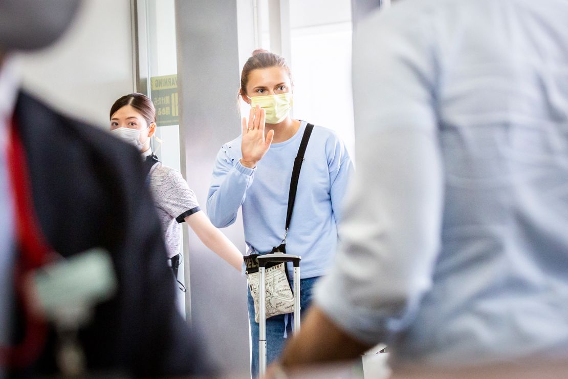 Belarus athlete Kristina Timanovskaya waves at the boarding gate for Austrian Airlines 0S52 at Tokyo's Narita international airport on August 4.