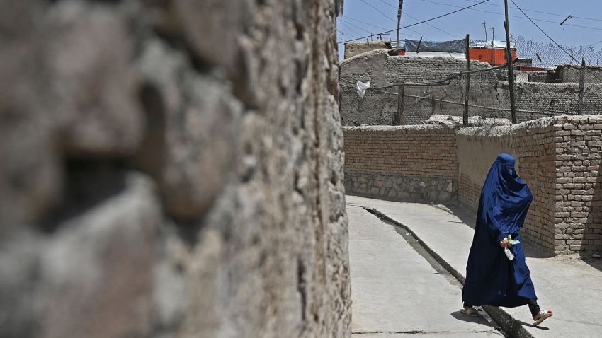 An Afghan woman walks through an alley in the old quarters of Kabul on July 12, 2021. (Photo by Sajjad HUSSAIN / AFP) (Photo by SAJJAD HUSSAIN/AFP via Getty Images)
