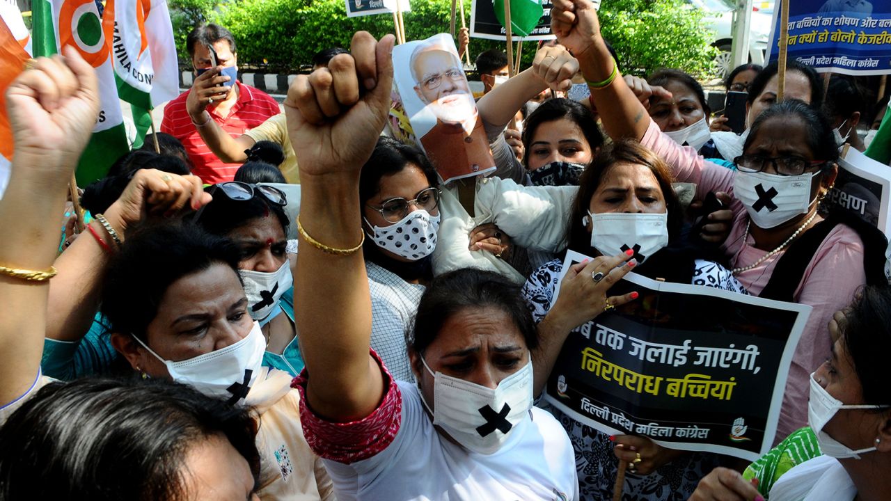 Members of the Indian Congress women's wing carry an effigy of Prime Minister Narendra Modi and Delhi Chief Minister Arvind Kejriwal to burn at a protest on August 3 in New Delhi.
