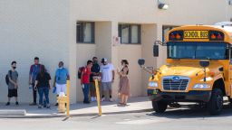 Students wait to leave near a school bus after their first day at Central High School in Phoenix on August 2, 2021.Central High School First Day