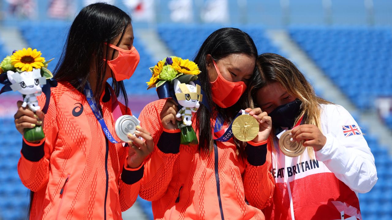 Kokona Hiraki, Sakura Yosozumi, and Sky Brown celebrate with their medals at the Tokyo Olympics.