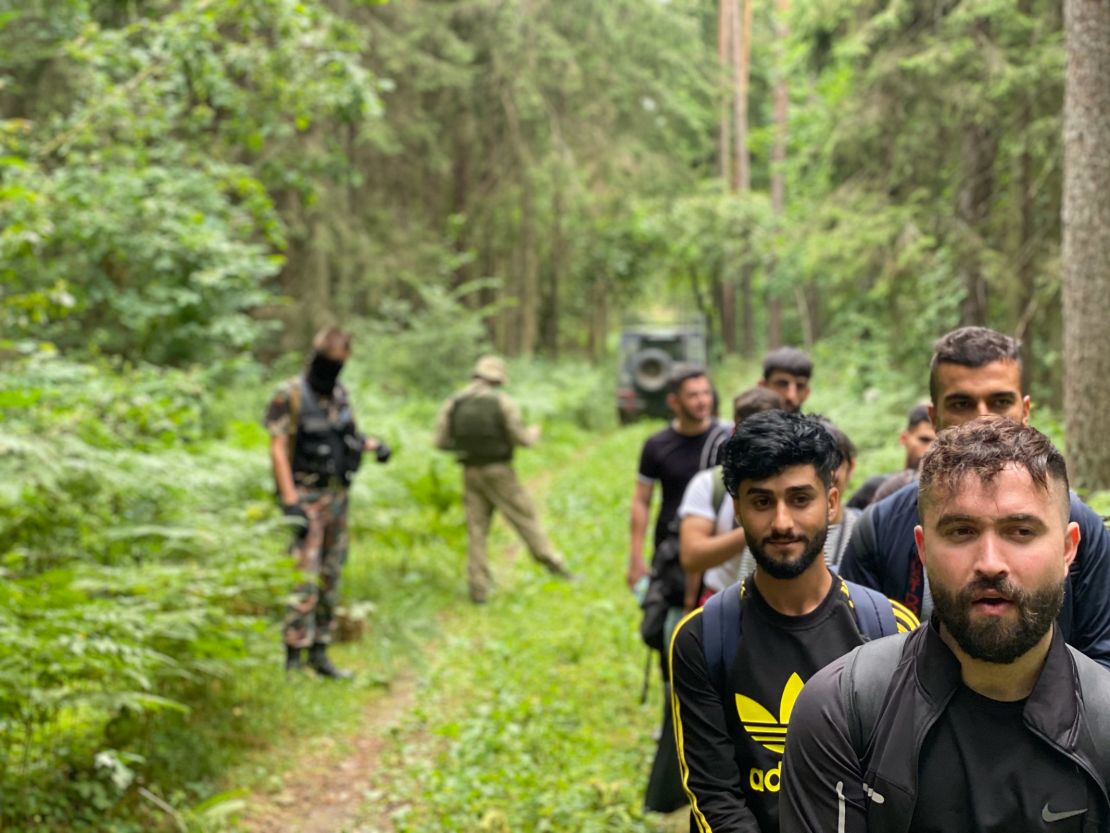 Iraqi migrants walk through the Lithuanian forest.