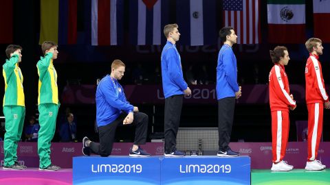 Race Imboden (third from left) takes the knee during the National Anthem Ceremony in the podium of men's foil team gold medal match at the 2019 Pan American Games in Lima, Peru.
