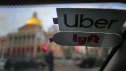 Uber and Lyft stickers are pictured inside a ride share vehicle outside the Massachusetts State House in Boston on Nov. 14, 2019. 