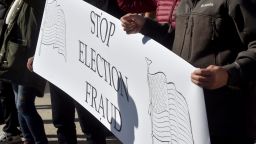 A protester holding a placard saying, stop election fraud, during the demonstration.