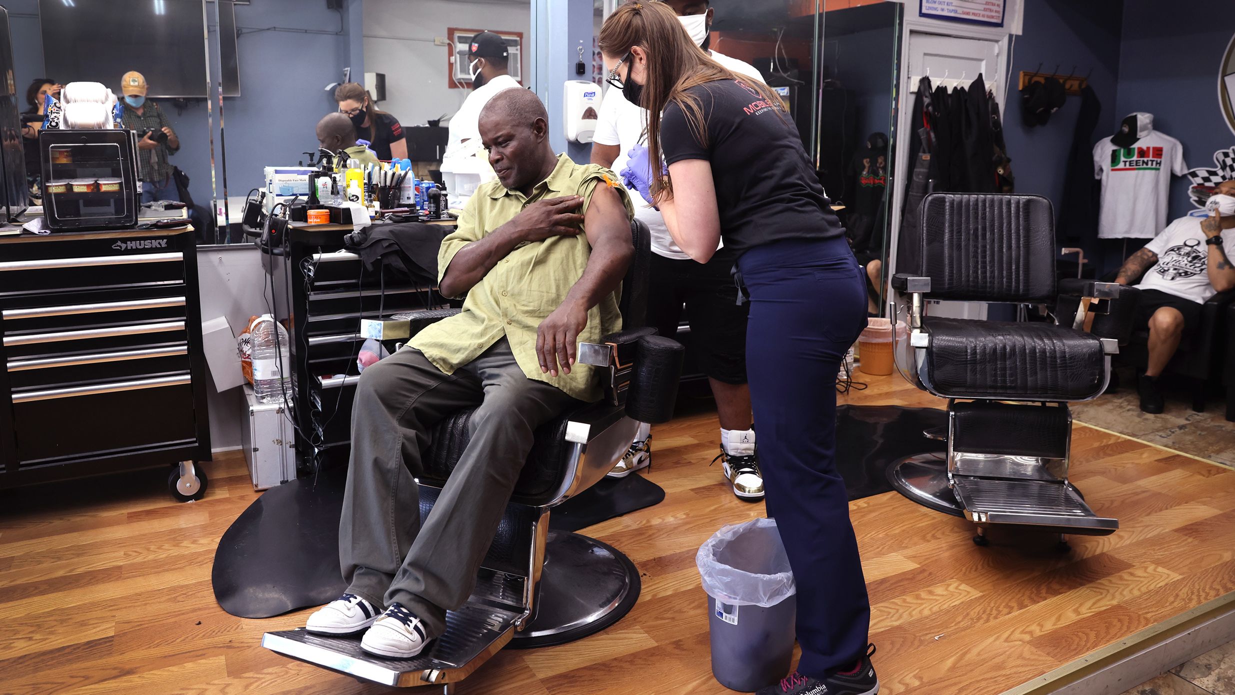 CHICAGO, ILLINOIS - JUNE 05: Eddie Stowe gets a COVID-19 vaccine from Amanda Kohler-Gopen at the It's Official Barbershop in the West Englewood neighborhood on June 05, 2021 in Chicago, Illinois.