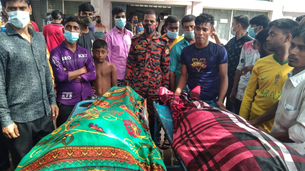 People gather around bodies of victims after lightning killed more than a dozen people in Shibganj, Bangladesh, on August 4. 
