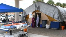 Nurses work at a treatment tent outside the emergency department at Holmes Regional Medical Center in Melbourne, Florida. The tent was set up to serve as an overflow area as the number of Covid-19 infections surges throughout Brevard County in Florida.