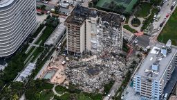 This aerial view, shows search and rescue personnel working on site after the partial collapse of the Champlain Towers South in Surfside, north of Miami Beach, on June 24, 2021. - The multi-story apartment block in Florida partially collapsed early June 24, sparking a major emergency response. Surfside Mayor Charles Burkett told NBCs Today show: My police chief has told me that we transported two people to the hospital this morning at least and one has died. We treated ten people on the site.