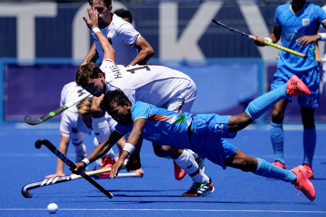 India's Vivek Sagar Prasad and Germany's Tobias Constantin Hauke compete for possession during the men's hockey bronze medal match. 