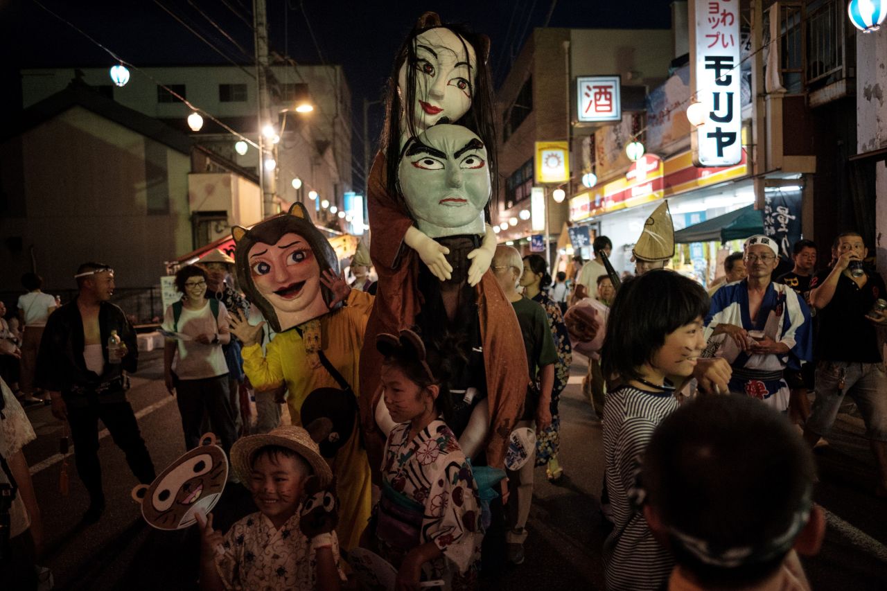 Dancers disguised as imaginary monsters take part in the Ikeda Awa Odori Festival in the city of Miyoshi on Japan's Shikoku island.