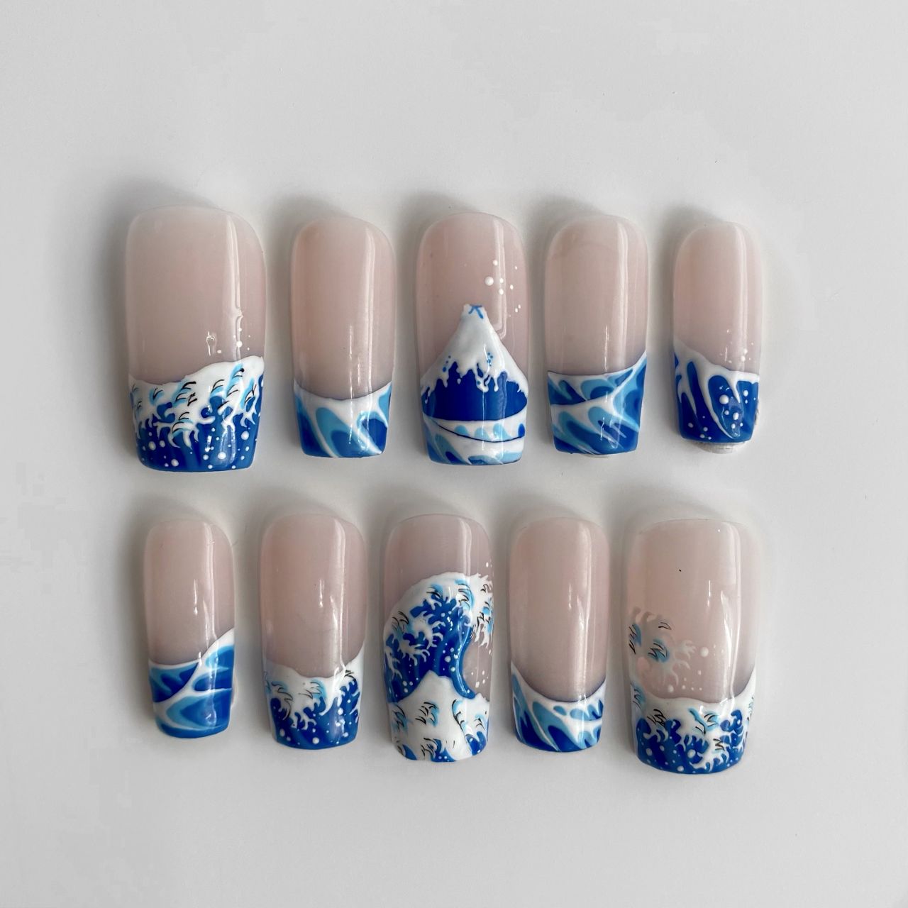 A close up of the press-on gel nails Emily Gilmour made for Team GB's Dina Asher-Smith, inspired by Hokusai's "Great Wave off Kanegawa."