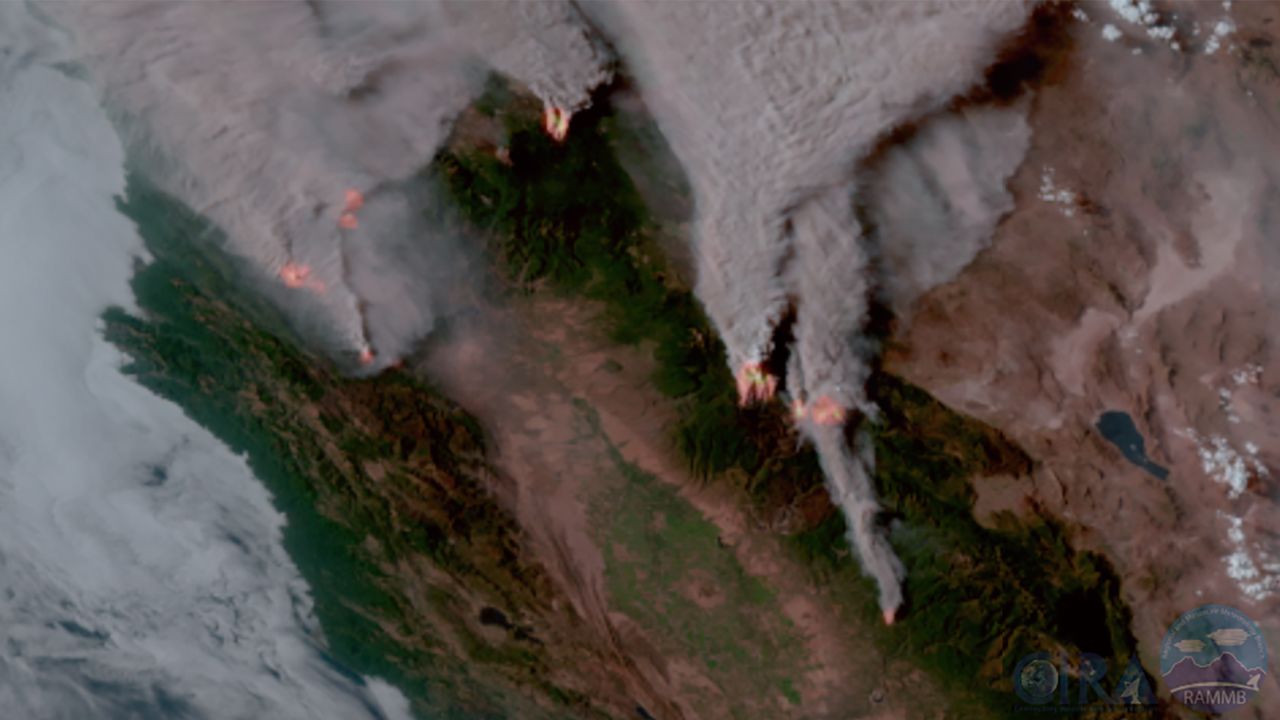 Several large wildfires and the smoke they're producing in Northern California were captured Wednesday using a sensor aboard NOAA's GOES-West satellite to depict the fire temperature (red color) and natural color of the surrounding area.