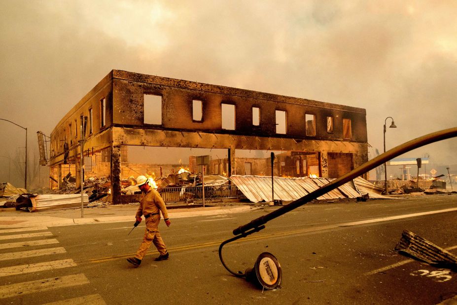 Operations Chief Jay Walter passes the historic Sierra Lodge as the Dixie Fire burns through Greenville, California, on August 4. The fire leveled multiple historic buildings and dozens of homes in central Greenville.